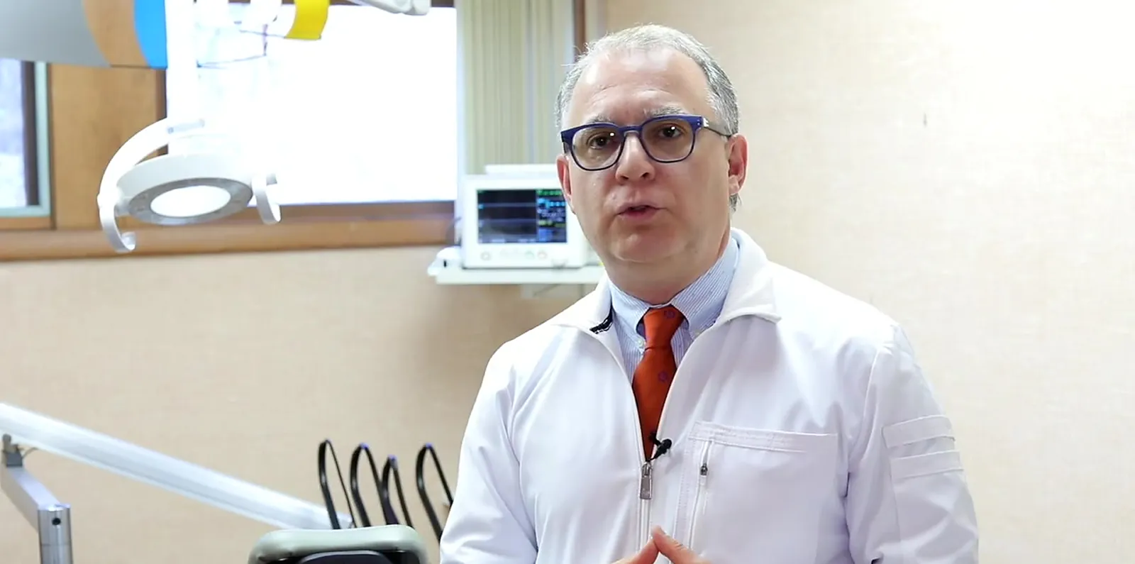 Dr. Robert Kirchmann in a Rye Dental Associates treatment room, beside the patient monitor.
