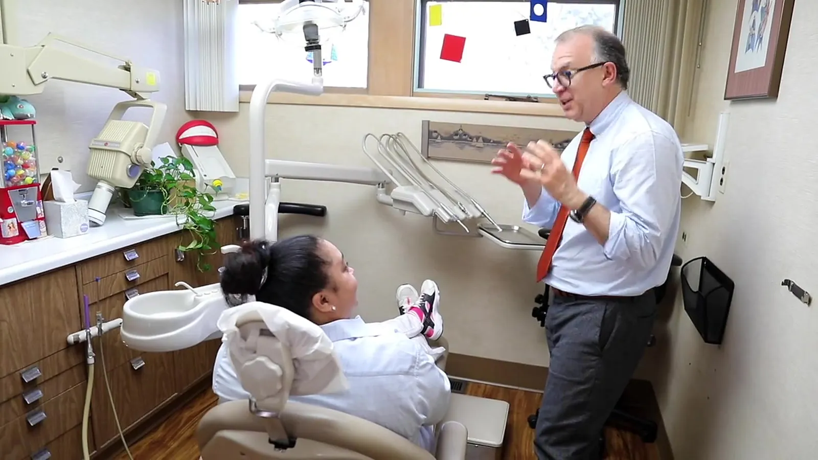 A dentist at Rye Dental Associates talking a patient through her treatment in a Cedar Street treatment room.