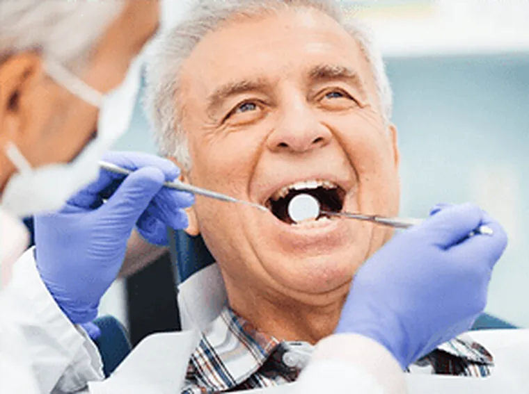 A dentist examining a patient who has come in with a problem.